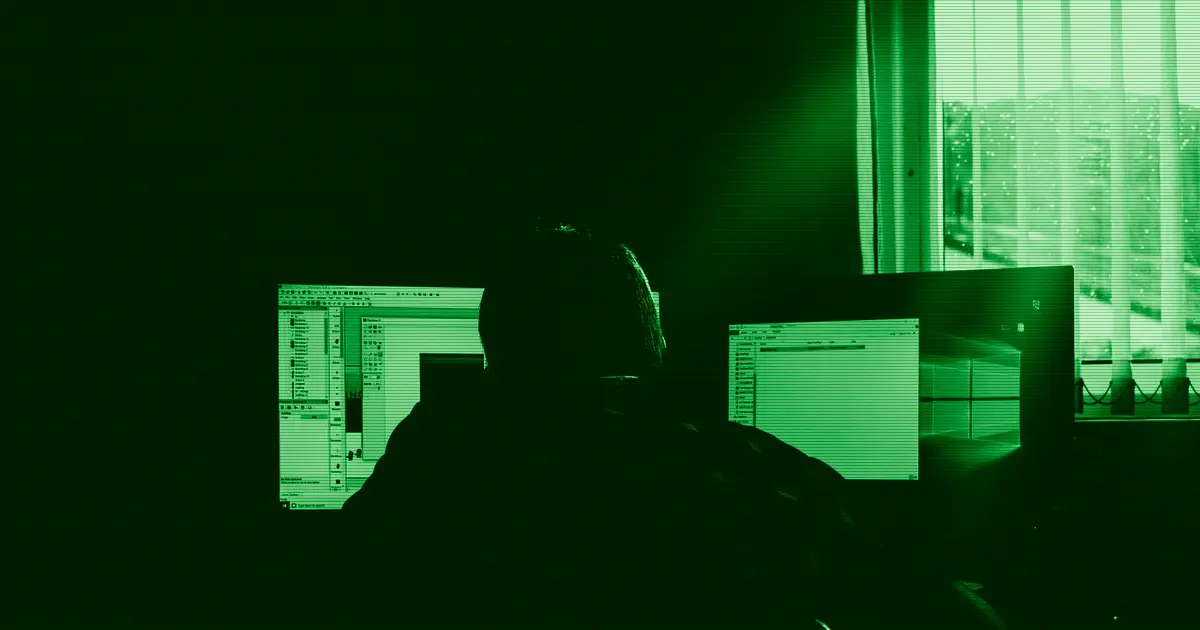 A person working in front of several computers