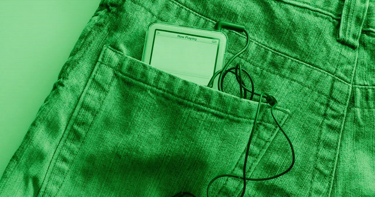 A hand holds a smartphone, the most widely used Linux device in the world