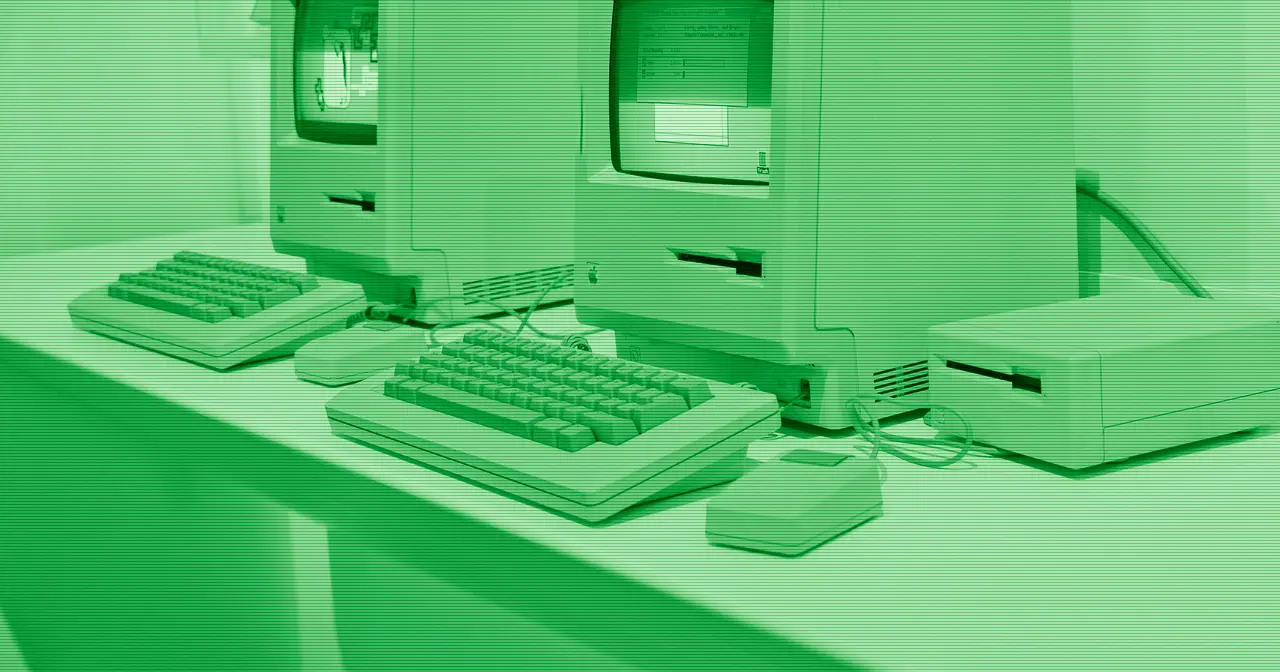 Vintage Apple computer on a dimly lit desk, evoking the heritage of the Mac
