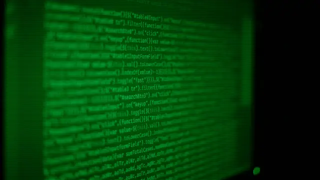 Screen full of code and a terminal, symbolizing the free software behind Linux distributions